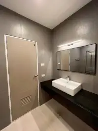 1 Bedroom Condo for Sale at View Talay 6 bathroom with black countertop sink, large mirror, and storage door