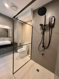 1 Bedroom Condo for Sale at View Talay 6 modern bathroom with glass-partitioned shower, rain showerhead, and toilet