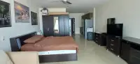 1 Bedroom Condo for Sale at View Talay 6 open-plan bedroom with wardrobe, kitchen, and TV area