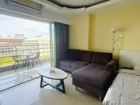 Studio Condo for Sale at View Talay 6 living area with sectional sofa, bed and balcony city view