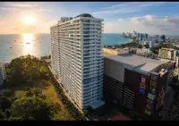 Studio Condo for Sale at View Talay 6 high-rise tower exterior view at sunset near the beach