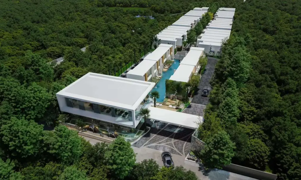 Villa La Richie: Aerial view of modern villas with white roofs, surrounded by lush green trees, featuring a long central pool.