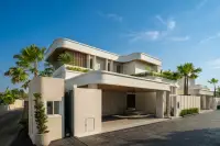 5 Bedroom House for Sale at Charin Pattaya modern two-story villa exterior with curved roofline and covered carport