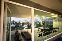 1 Bedroom Condo for Rent at VN Residence 3 fitness gym with treadmill, elliptical and weights overlooking city