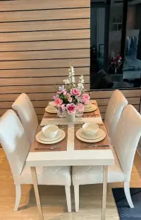 1 Bedroom Condo for Sale at La Santir dining table set with floral centerpiece and white chairs