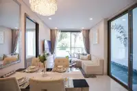 1 Bedroom Condo for Sale at Copacabana Coral Reef bright living and dining room with crystal chandelier, large mirror, cream sofa and garden balcony view