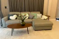 3 Bedroom House for Sale at SP Village 1 living room with grey L-shaped sectional sofa, oval wooden coffee table and floral vase
