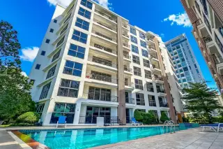City Garden Pratumnak, aerial view of outdoor swimming pool with sun loungers and building balconies