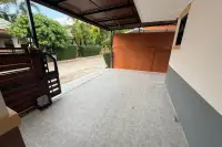 3 Bedroom House for Sale at Baan Dusit Pattaya Park covered driveway with tiled floor and automatic gate.