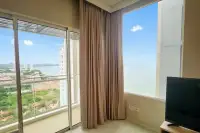 1 Bedroom Condo for Sale at Veranda Residence Pattaya living area with panoramic sea and city views through large glass windows