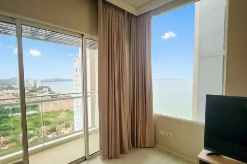 1 Bedroom Condo for Sale at Veranda Residence Pattaya living area with panoramic sea and city views through large glass windows
