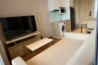 1 Bedroom Condo for Rent at Once Pattaya open-plan living room with TV kitchen washing machine and fridge