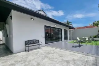 Royal Prestige outdoor patio with sliding glass doors, garden bench, dining set, and landscaped lawn