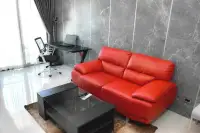 1 Bedroom Condo for Sale at Water Park living room with red leather sofa and marble accent wall