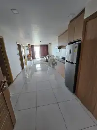 2 Bedroom Condo for Sale at Whale Marina open-plan kitchen and living area with tiled flooring and stainless fridge