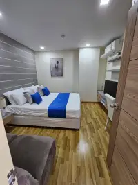 2 Bedroom Condo for Sale at Whale Marina second bedroom with king bed, wall art, and wooden flooring