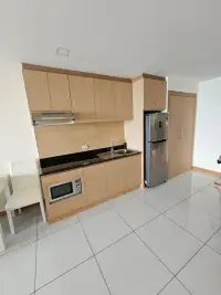 2 Bedroom Condo for Sale at Whale Marina kitchen with wood cabinetry, built-in sink, and microwave
