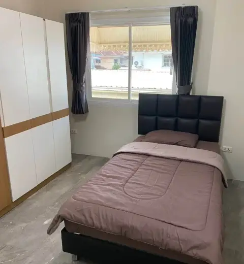 3 Bedroom House for Rent at Wonderland II cozy bedroom with black headboard bed and built-in wardrobe