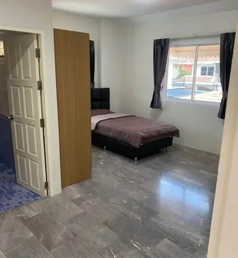 3 Bedroom House for Rent at Wonderland II bedroom with single bed, wardrobe, and window view of neighborhood