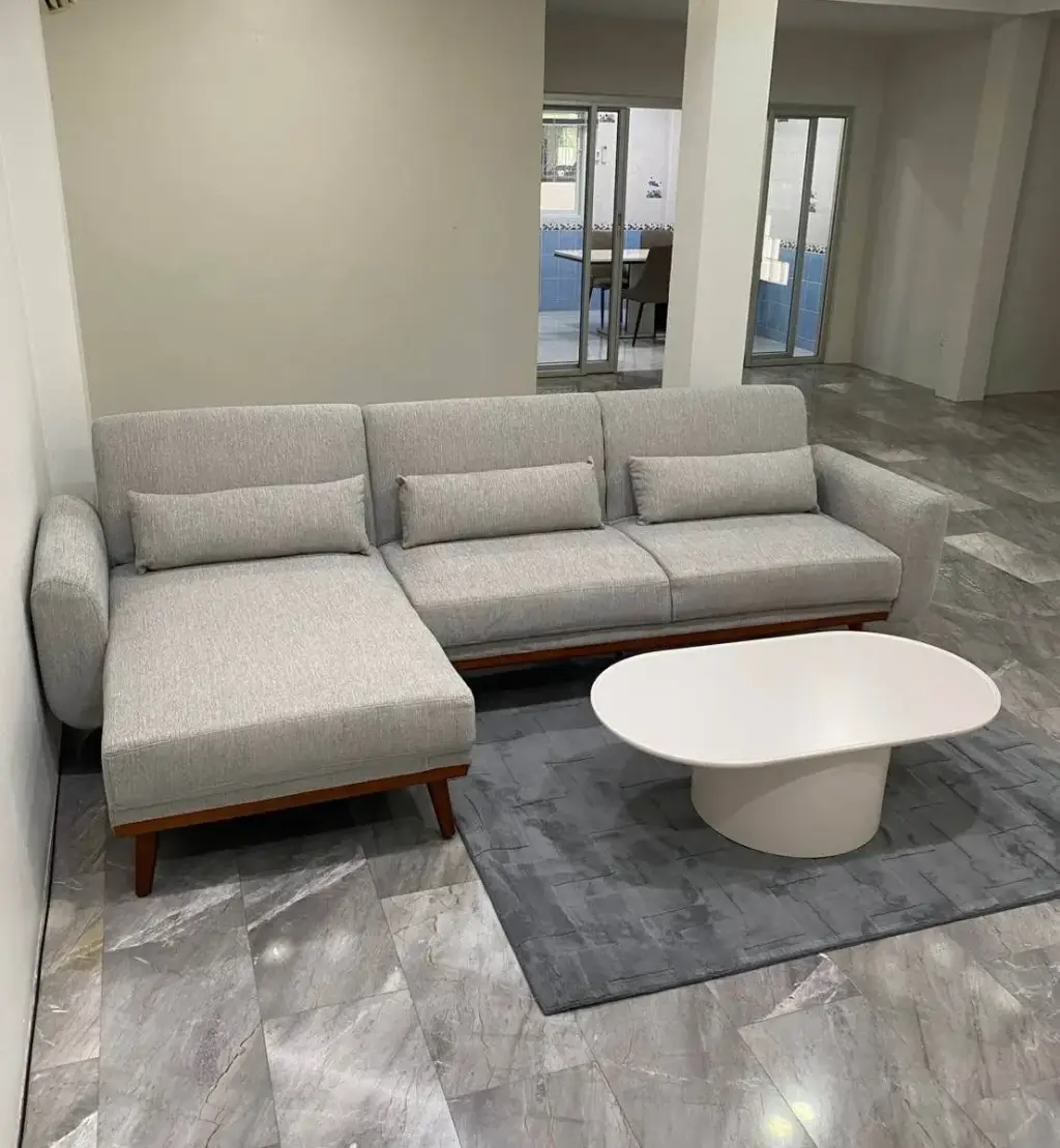 3 Bedroom House for Rent at Wonderland II living room with grey sectional sofa and oval white coffee table