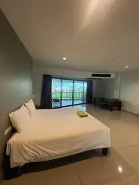 1 Bedroom Condo for Sale at Wongamat Privacy bedroom with balcony offering city and sea view at dusk