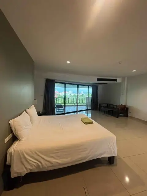 1 Bedroom Condo for Sale at Wongamat Privacy bedroom with balcony offering city and sea view at dusk