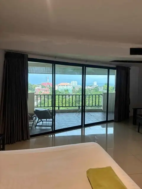 1 Bedroom Condo for Sale at Wongamat Privacy balcony view with seating area overlooking cityscape and sea