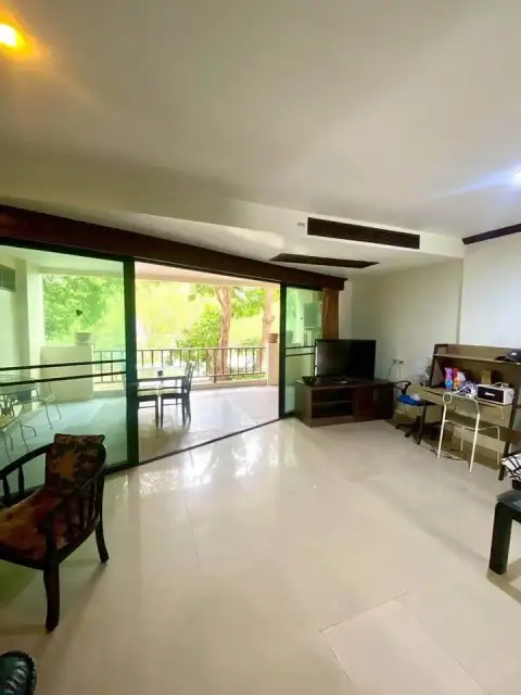1 Bedroom Condo for Sale at Wongamat Privacy living room with balcony access and TV console