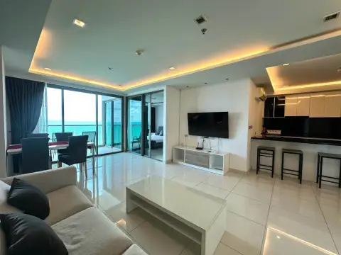 2 Bedroom Condo for Rent at Wongamat Tower open-plan living area with dining table, TV and kitchen bar