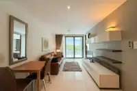 2 Bedroom Condo for Sale & Rent at The Sanctuary Wongamat bright living and dining area with balcony and garden view
