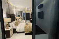 Studio Condo for Sale at Grand Solaire Noble open-plan studio interior viewed from balcony showing bed, TV, and marble flooring