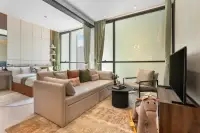 1 Bedroom Condo for Sale at Once Wong Amat: living area with a large sofa, rug, rocking horse, and floor-to-ceiling windows.