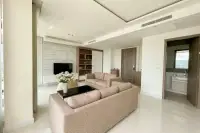 3 Bedroom Condo for Sale at Del Mare modern living room with marble TV feature wall, wooden shelving, and en-suite bathroom entrance