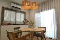 4 Bedroom House for Rent at Supalai Palm Ville Sukhumvit - Rongpo - dining area with round wooden table, chairs, and woven pendant lights.