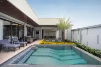 3 Bedroom House for Sale at Zensiri Lakeside Pool Villas private pool with jacuzzi, lounge chairs, and palm tree courtyard