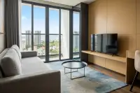 1 Bedroom Condo for Rent at Beverly Mountain Bay Pattaya living area with sofa and floor-to-ceiling city and sea view windows