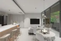 1 Bedroom Condo for Sale at Celine Wongamat open-plan living and dining area with kitchen bar stools and garden view balcony