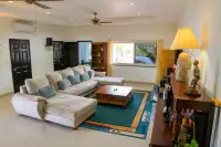 4 Bedroom House for Sale & Rent at Miami Villas spacious living room with L-shaped sofa, wooden coffee table and ceiling fan