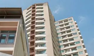 Sriracha Condo View close-up of curved building exterior with multiple balcony tiers