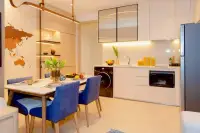 1 Bedroom Condo for Sale at Once Wong Amat open-plan kitchen and dining room with white cabinetry and blue chairs