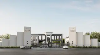 RAKHA PATTAYA main entrance gate with modern design, two cars, and prominent signage.