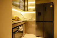 2 Bedroom Condo for Sale at Arom Jomtien compact kitchen with glass cabinets, stone countertop and Samsung fridge