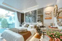 2 Bedroom Condo for Sale at The Riviera Santa Monica bedroom with large bed, marble accent wall, and pool view.