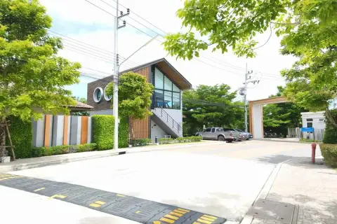 Supalai Ville Pattaya - Motorway clubhouse exterior with large glass windows and speed bump at entrance