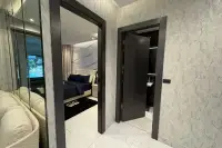 2 Bedroom Condo for Sale at Zenith Pattaya hallway with marble-effect walls leading to bedroom and bathroom doors