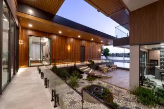 M Mountain Lake courtyard with illuminated stairs, landscaped garden, and an outdoor living area.
