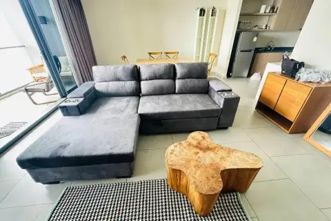 2 Bedroom Condo for Rent at Zire Wongamat gray sectional sofa with wooden coffee table and kitchen area in background