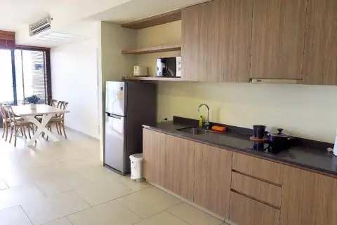 2 Bedroom Condo for Rent at Zire Wongamat modern kitchen with wooden cabinets, sink and dining area