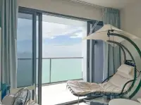 1 Bedroom Condo for Sale at Zire Wongamat balcony hanging egg chair with sea view
