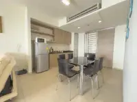 1 Bedroom Condo for Sale at Zire Wongamat kitchen with dining table and six chairs